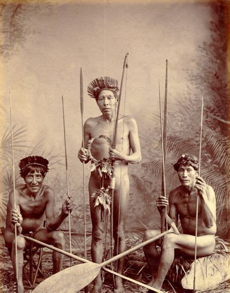 An Old Photo Of Three Native American Men With Spears And Paddles In