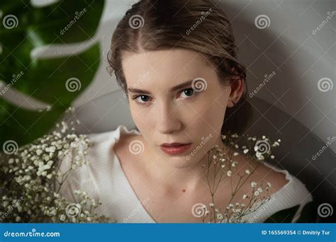 Blonde Woman In Bath With Flowers And Green Leaves Stock Photo Image