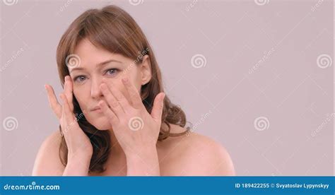 Woman Applying Anti Age Cream On Her Soft Face Skin Under Eyes Using
