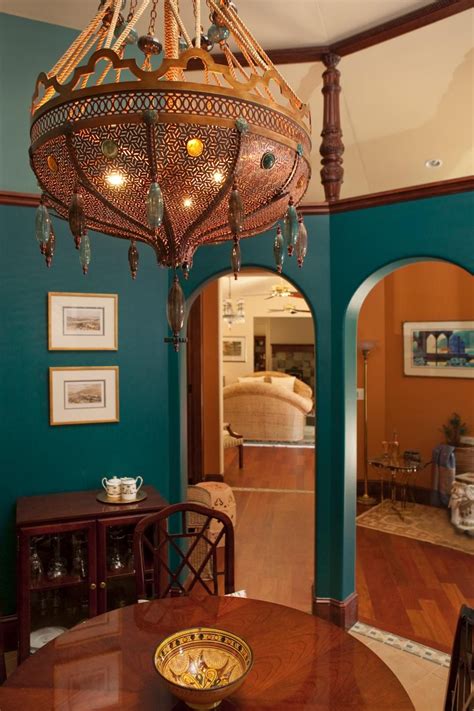 A welcoming moroccan living room with lots of color and pattern, with low tables and pendant lamps. An ornate chandelier takes center stage in this ...