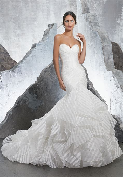The designer is known for a devotion to long and flowing styles, with trumpet skirts and mermaid styles taking center stage. Karina Wedding Dress | Style 5604 | Morilee