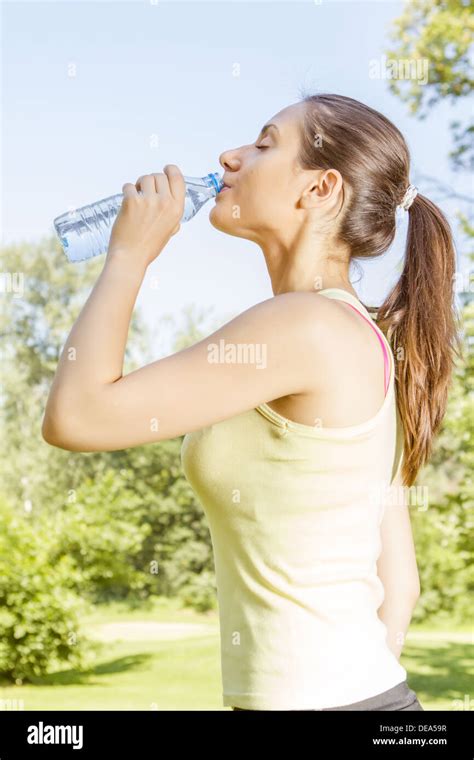 Fitness Girl Drinking Water In The Park Stock Photo Alamy
