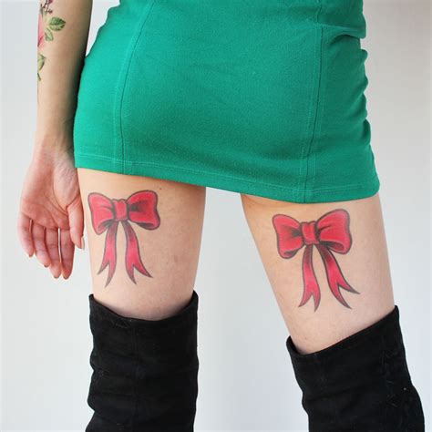 A Woman S Legs With Bows On Them And Tattoos On The Lower Leg