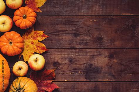 Thanksgiving Background Apples Pumpkins And Fallen Leaves On Wooden