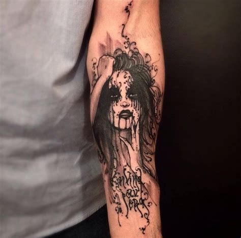 black ink typical forearm tattoo of creepy woman with lettering tattooimages