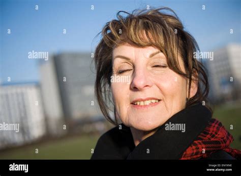 Lateral Head Portrait Of A Mature Woman In Fuzzy Urban Light Deep
