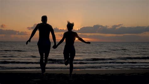 Sexy Couple Running Beach Sunrise Stock Footage Video 100