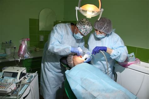 Dental Implantation Operation On A Patient At Dentistry Office Dental