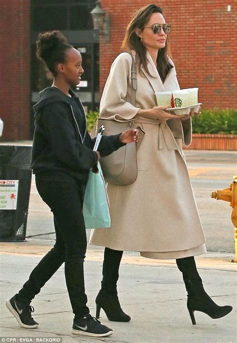 Angelina Jolie Picks Up Coffee As Vivienne And Sahara Cart The Bags