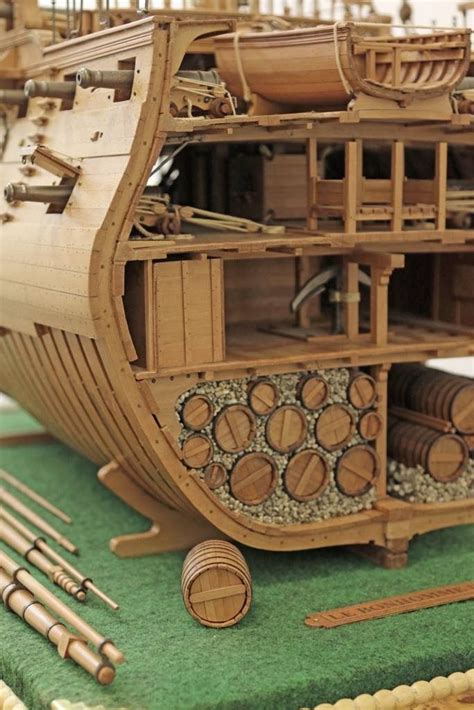 A Wooden Model Of A Ship With Lots Of Woodworking Tools On Its Side