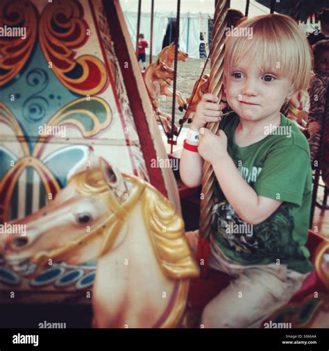 Boy On A Carousel Stock Photo Alamy