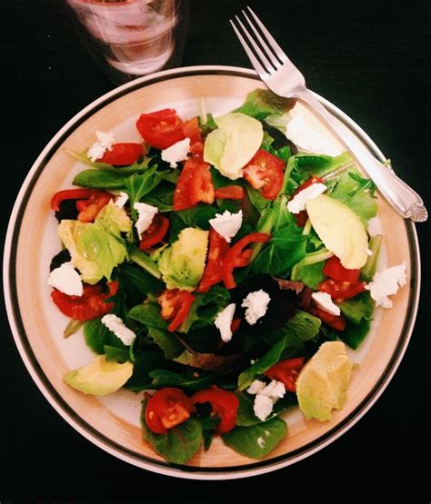 delicious avocado tomato and goat cheese salad with mixed greens and balsamic vinaigrette