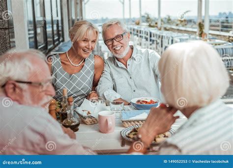 cheerful mature couple sitting close to each other stock image image of friends interaction