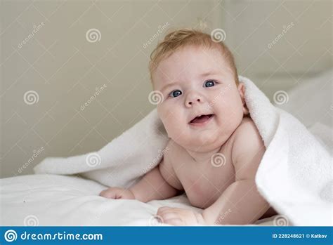 Bright Portrait Of A Cute 4 Months Baby Lying Down On A White Towel