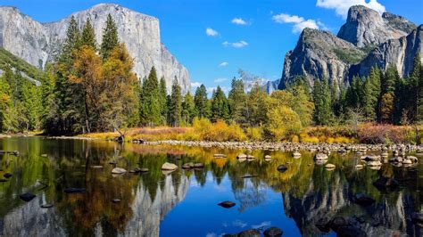 Rock Mountain Green Yellow Trees Reflection On Water Under Blue Sky Hd