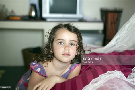 Young Girl Looking Into The Camera With A Photo Getty Images