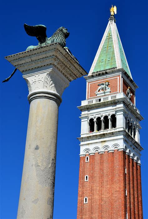 St Mark’s Bell Tower And Winged Lion Column In Venice Italy Encircle Photos
