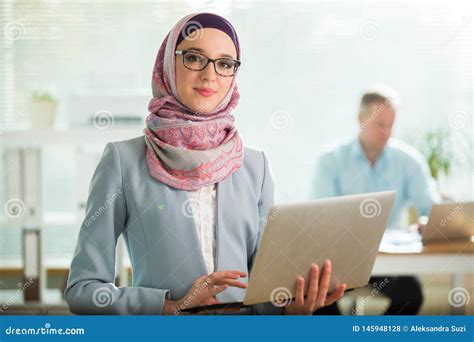 Beautiful Young Working Woman In Hijab And Eyeglasses Smiling In Office