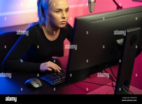 Focused Professional E Sport Gamer Girl With Headset Playing Online