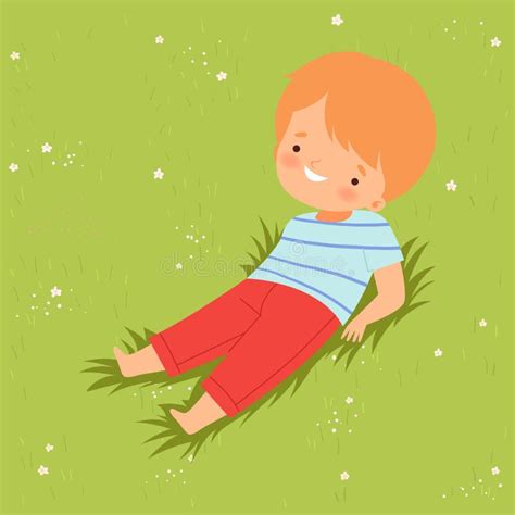 Smiling Boy Lying Down On Green Lawn Cute Kid Having Fun Outdoors