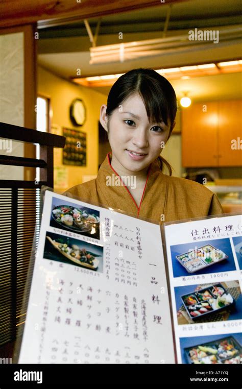 Waitress Showing Menu At Japanese Restaurant Stock Photo Alamy
