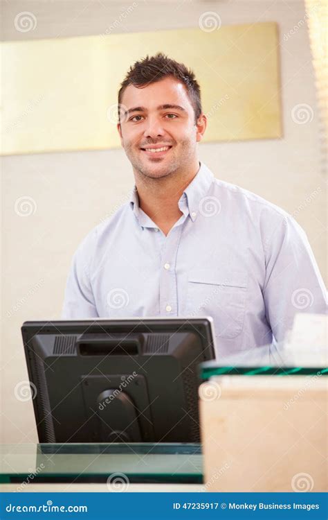 Portrait Of Male Receptionist At Hotel Front Desk Stock Image Image