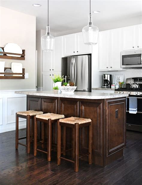 Dark kitchen cabinets can sometimes look too strong and overwhelming, but a good way to tone it down is to use a light colored countertop and a light colored kitchen island. White Cabinets, Dark Kitchen Island for Your Home