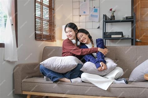 premium photo asian beautiful lesbian women couple hugging girlfriend in living room