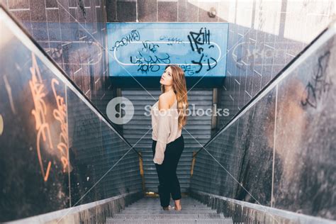 Young Blonde Caucasian Woman Posing On Abandoned Escalator Looking Up