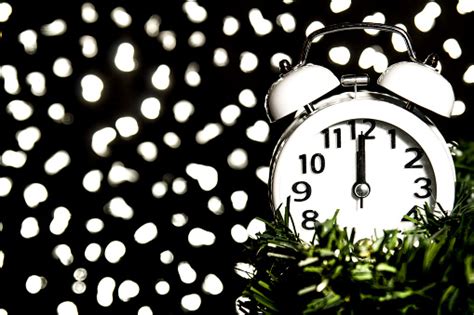 New Year At Midnight Clock At Twelve Oclock With Holiday Lights Stock