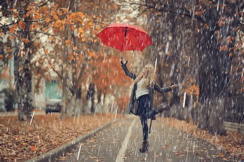 October Walk In The Rain A Young Woman With A Red Umbrella In The