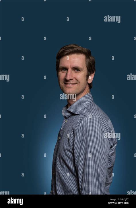 Smiling Man With Head Turned Towards Camera Stock Photo Alamy