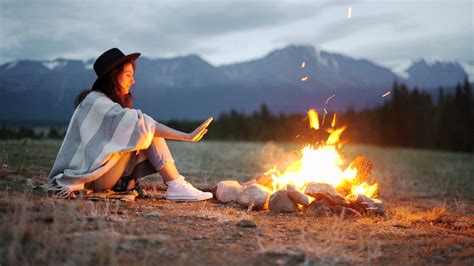 Woman Warming Her Hands Over A Hot Campfire Free Stock Video