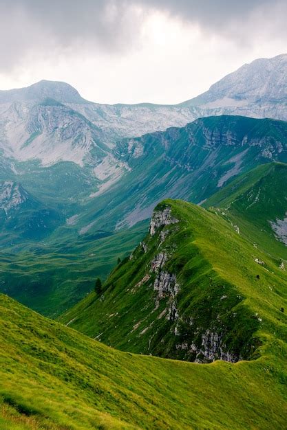 Beautiful Vertical Shot Of A Long Mountain Peak Covered In Green Grass