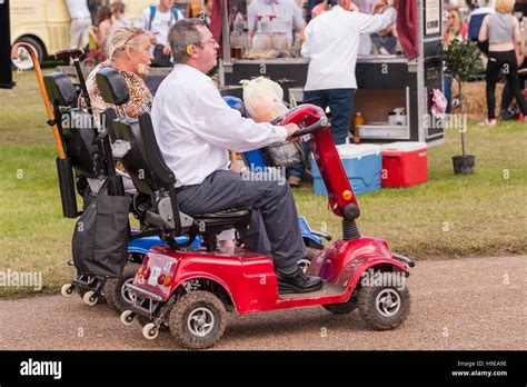 Two People On Mobility Scooters At The Royal Norfolk Show In The