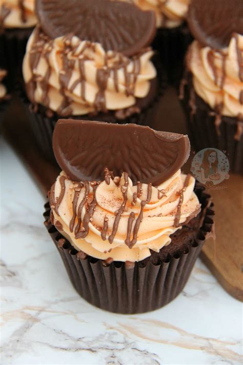 A chocolate cupcake with chocolate buttercream and sprinkles. Terry's Chocolate Orange Cupcakes! - Jane's Patisserie