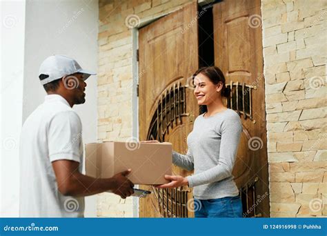 Home Delivery Courier Delivering Package To Client Stock Photo Image
