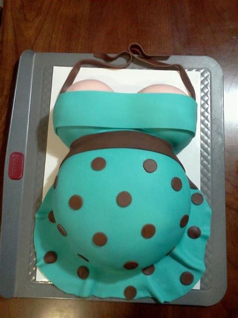 A Cake Shaped Like A Pregnant Belly With Brown And Blue Polka Dots On