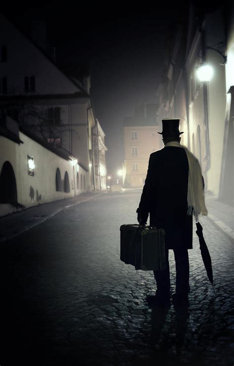 Victorian Man With Top Hat Carrying A Suitcase Walking In The Old Town