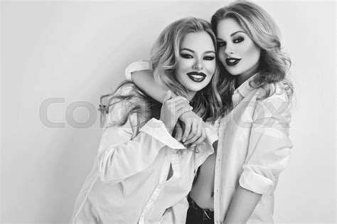 Two Beautiful Girls In Men Shirts And Jeans Stock Image Colourbox