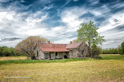 An Old Farmhouse In The Middle Of A Field In North Carolina Old