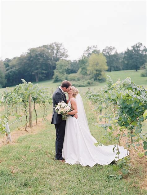 Bride And Groom Kissing In Vineyard