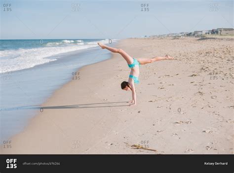 Girl Doing Handstand On Beach Stock Photo Offset
