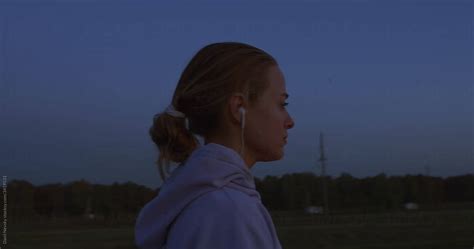 Young Woman Putting On Hood In Evening By Stocksy Contributor Danil