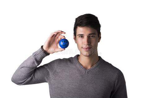 Handsome Young Man Holding Small Ball With Smiley Face On It Stock