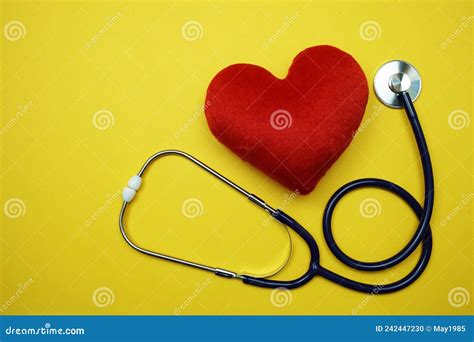 Heart And Stethoscope With Space Copy On Yellow Background Stock Photo