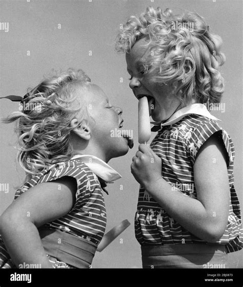 Two Sisters Licking Ice Lollies On The Beach At Bognor Regis June 1960