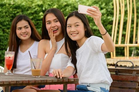 Premium Photo Three Happy Young Asian Women As Friends Taking Selfie Together At The Coffee