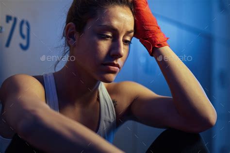 Pensive Athletic Woman Resting In Locker Room After Sports Training
