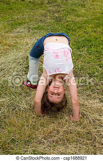 Bending Over Backwards Little Smiling Girl Gymnast Bends Over